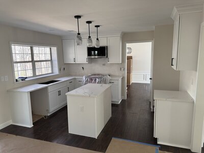 kitchen with white countertops and dark floors to show kitchen remodeling atlanta by Varilko Remodeling