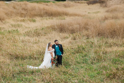 A wedding couple poses for portraits at Dakota Dunes Country Club in South Dakota. True color photo by Claire Katan Creative.