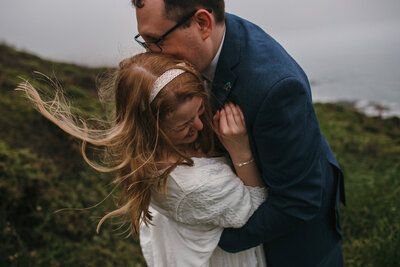 Couple embrace on the cliffs in south Cornwall