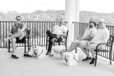 Black and white photo of groomsmen on the wrap around porch.
