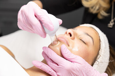 a woman getting a facial at Skin Sanctuary