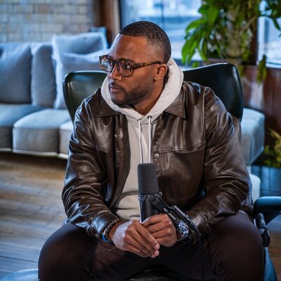Dior Johnson interviewing a guest on the Perfecting Progression podcast in studio