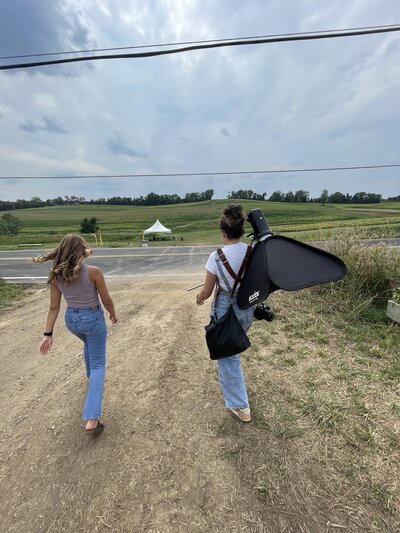 A student and photographer heidi iliff walk-through field on the way to a shoot