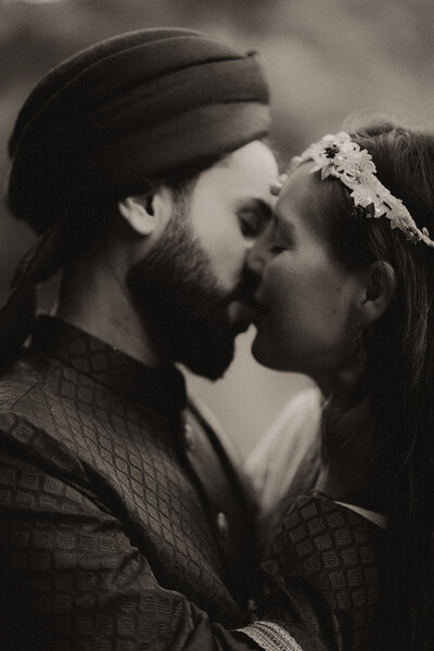 An emotional and romantic black and white photo of an Indian groom and his bride kissing during their Bellingen wedding at Evermoore Castle