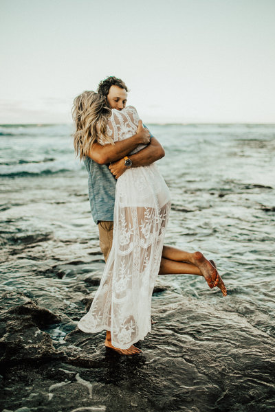 couple hugging by ocean