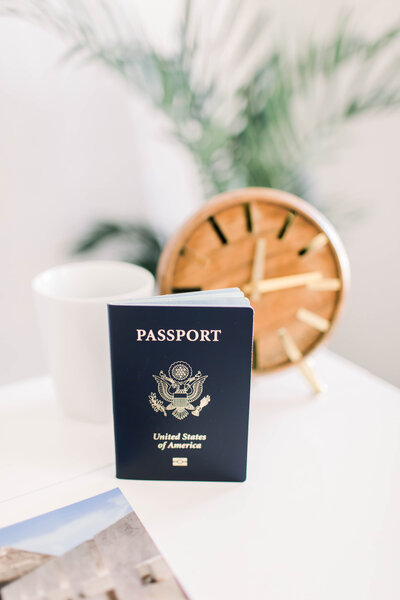 passport on table in front of clock