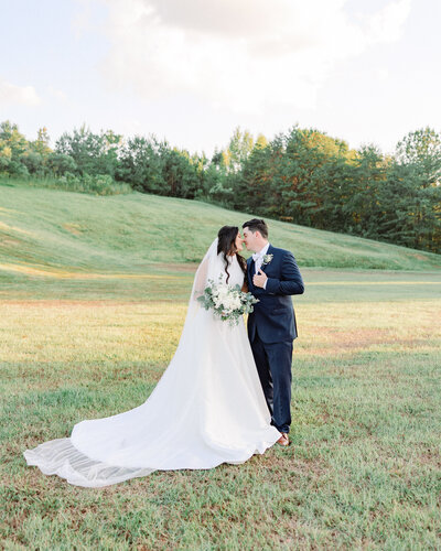 Lauren and Zac smiling together at their countryside wedding, highlighting Abby Bell Photography's expertise as an Alabama couples and engagement photographer.