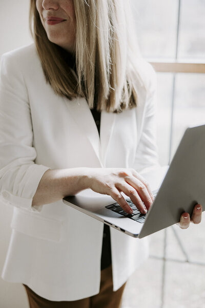 a woman typing on a laptop