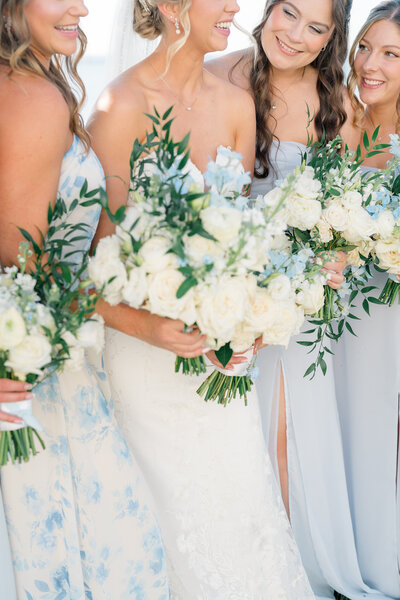 The Corteses Newport Wedding Photographer and Videographer | Serving CT, RI, and beyond | Close up of bride with bridesmaid and flowers