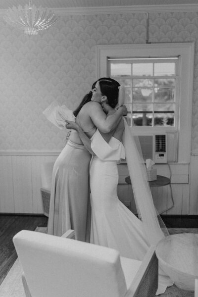 Bride hugs maid of honor Atlanta Documentary Wedding Photographer