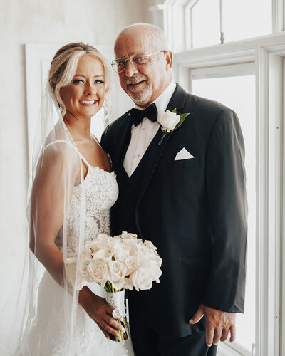 bride with father smiling at camera