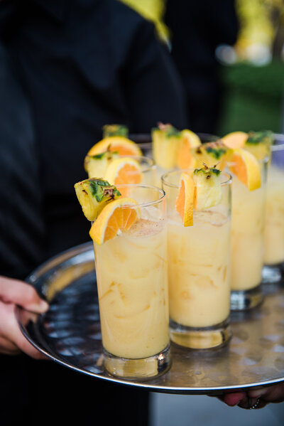 tray of vibrant yellow pineapple margaritas