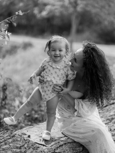 Black and white photo of mom and daughter smiling