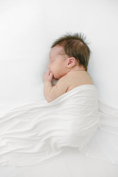 baby in all white sleeping