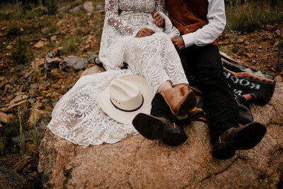 Elopement couple riding horses in the colorado mountains