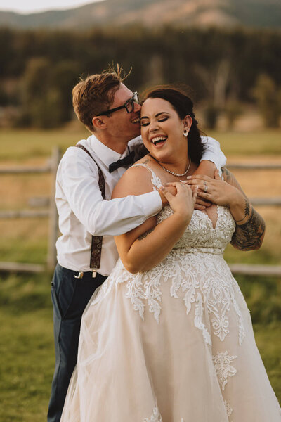 Bride and groom laughing during golden hour