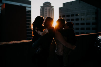 silhouette of a family at golden hour with the background of  downtown st louis