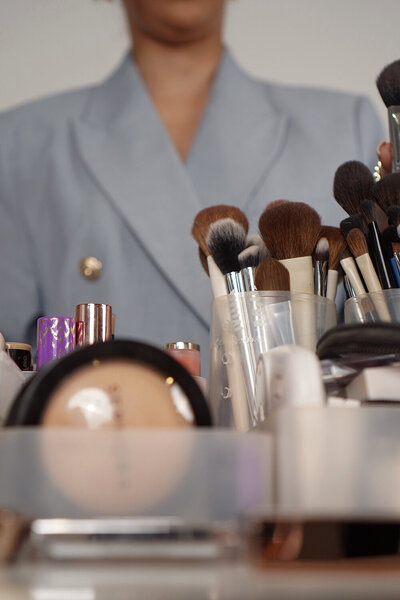 makeup artist and educator in NYC dressed elegantly with professional skincare and makeup tools, offering skin-prep-focused bridal services.