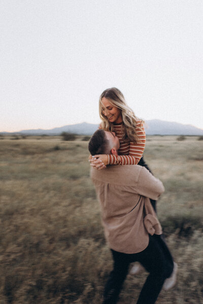 A husband and wife chasing each other in a Scottsdale field