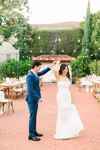 Bride and groom dancing twirling at Darlington House in La Jolla, California.