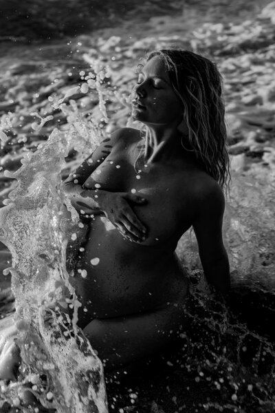 artistic black and white maui maternity portrait in the ocean