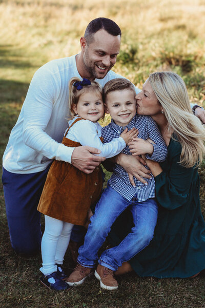 Mom, dad, son, and daughter smiling for family photos.