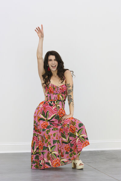 Model in bright floral dress posing in studio in Malta, New York