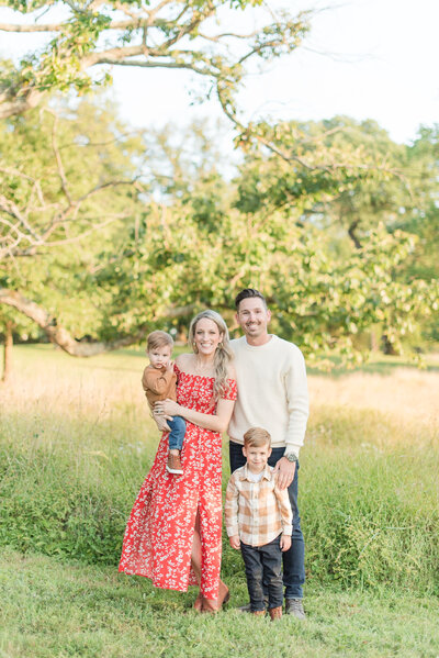 family of 4 in a sunny field