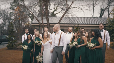 Wedding party is walking together in unison with bride and groom