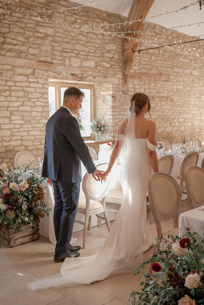 Bride and groom admiring the indoor wedding reception décor at Caswell House