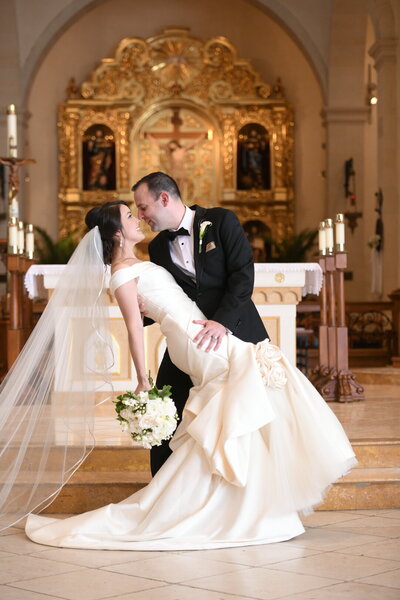 Bride and groom kiss at the altar