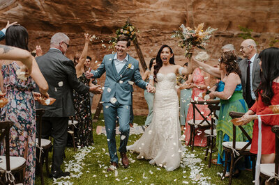 happy-couple-walking-down-aisle-colorado-rocks