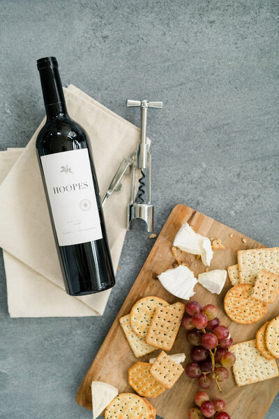 flat lay of Hoopes wine bottle and cheese and crackers board