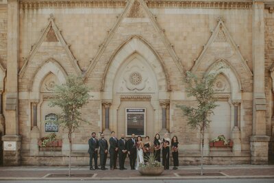 Wedding part outside stone church