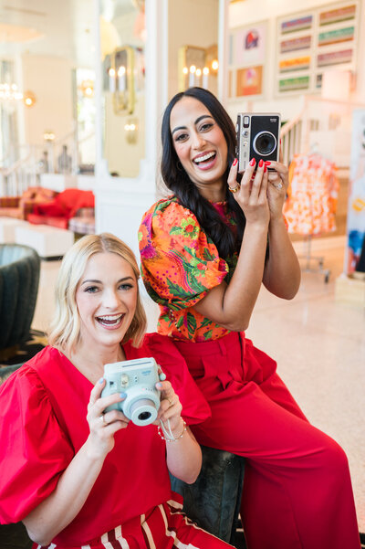 Dr. Brooks and Dr. Templeton, orthodontists in Nashville, TN holding vintage cameras