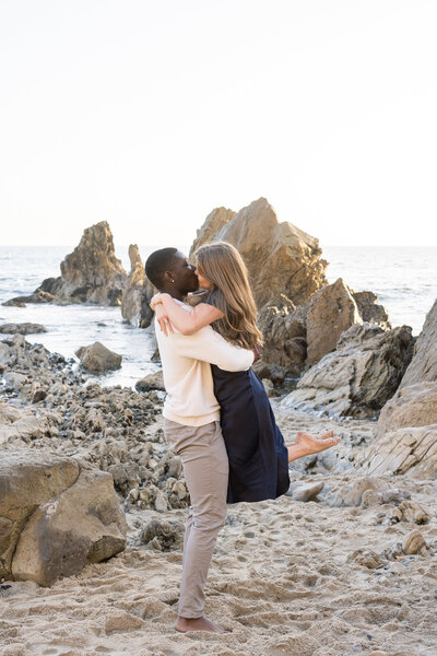 romantic couple kissing on the beach