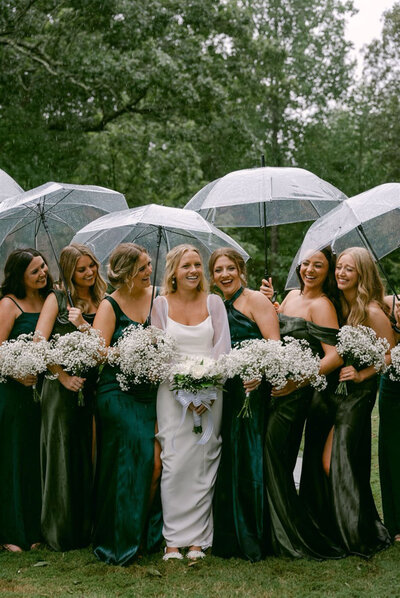 Bridal party holding umbrellas given by Raleigh wedding planners