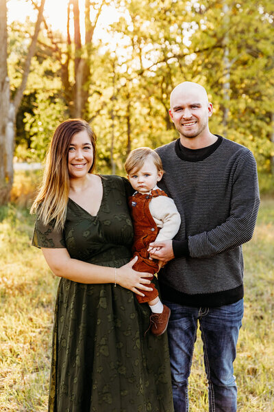 mother and father holding their two year old son for their family photo session