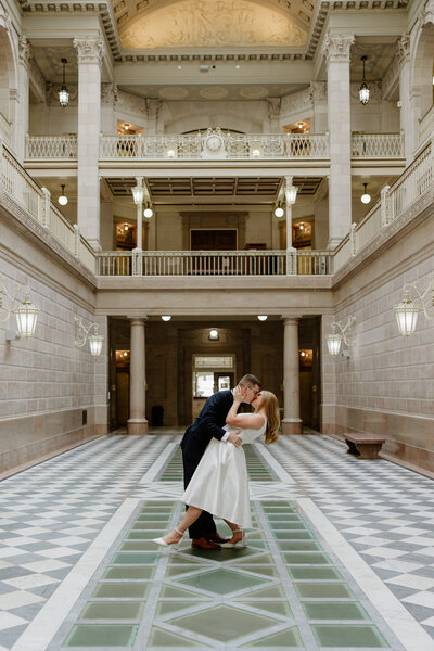 A couple doing a dip and kiss at Hartford City Hall 