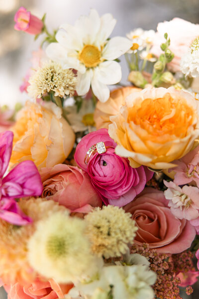 Close-up of wedding ring nestled in bride’s bouquet at Hidden Vineyards wedding venue in Maize, Kansas