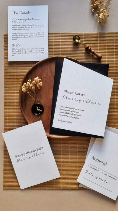Minimalist angle-cut wedding stationery suite in monochrome colour palette.