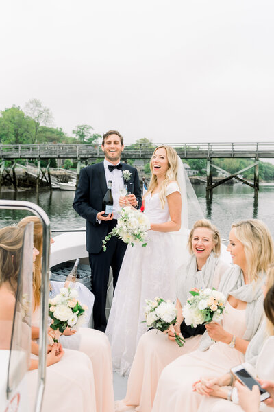 Married couple celebrating with wedding party on a boat