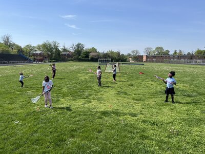 Young girls learning lacrosse