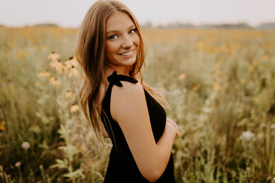 Senior girl sitting on the ground smiling