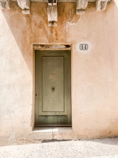 image of green door in dusty building by Sarah, who does copywriting for small businesses