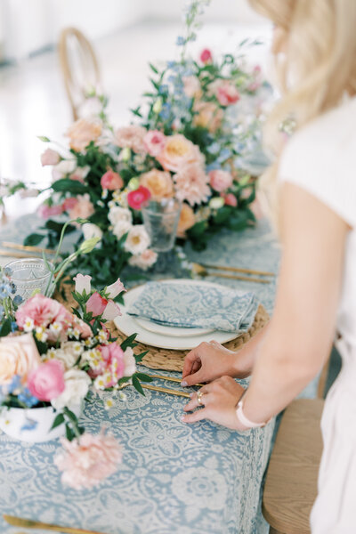 Helena Elizabeth putting together tablescape by  wedding planner Tampa FL