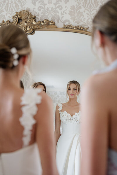 Bride and groom facing each other inside the bride's veil