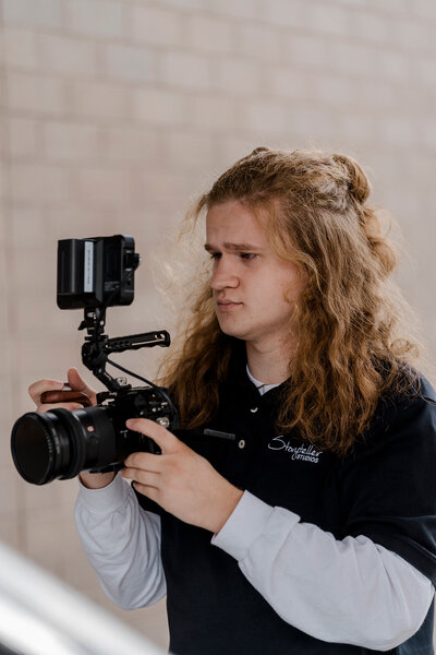 production assistant walker dial operates a camera outside
