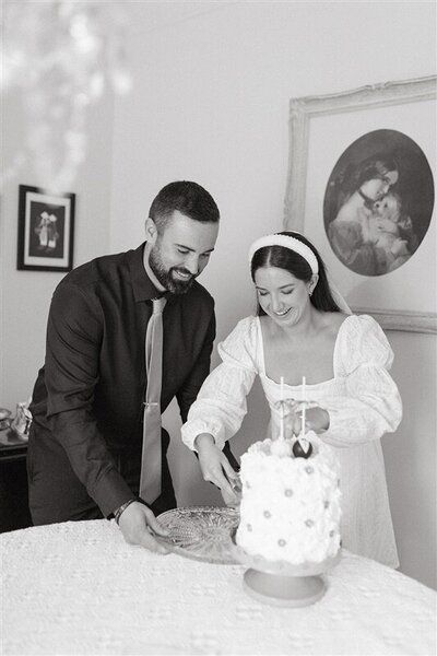 bride and groom cutting wedding cake