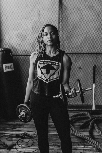 woman holding a two dumbells
